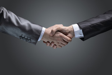 close up.handshake of business partners on a dark background