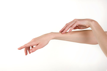 Elegant female hands on a white background. Self care, skin care.

