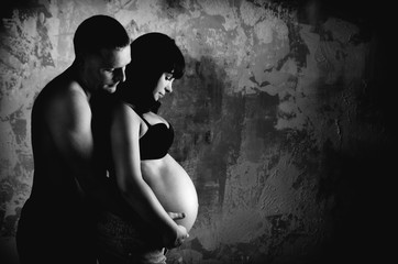 Black and white studio photo of a married couple waiting for their baby.
- 235446228