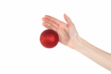 Red shiny Christmas ball in an elegant female hand. Isolated on white background.
