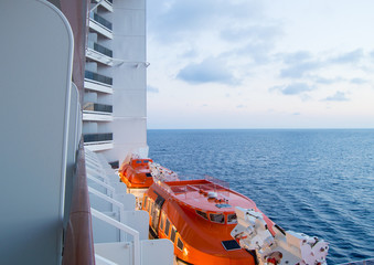 Sunset on the Mediterranean sea, a beautiful view from the cruise ship, visible lifeboats