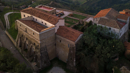 Fototapeta premium Aerial view at sunset of the castle built on the mountain where Montecalvo Irpino rises in Italy.