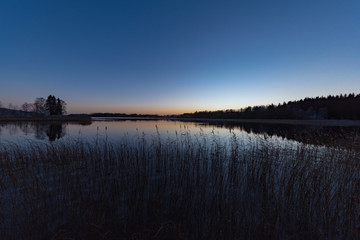 sunset over a little lake in sweden november 2018