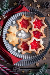 Linz cookies with jam in Christmas decorations, traditional cookies Austria, top view, selective focus