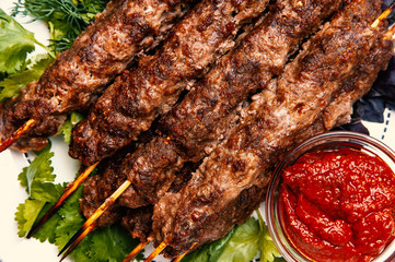 Lula kebabs , minced beef grilled on a skewers with a dip sauce