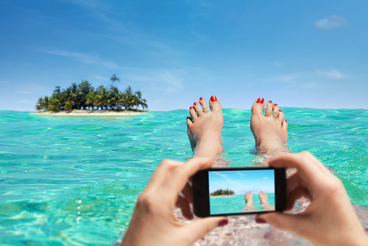 Woman is taking a picture on vacation with the smartphone