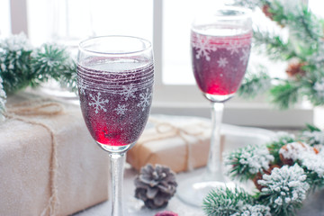 Festive cherry liquor on a snow table in Christmas decorations, horizontal