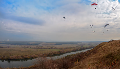 Paragliders flying over the autumn river Don. Place-village Storozhevoe, Voronezh region.