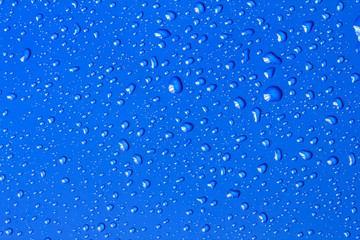 Naklejka na ściany i meble The Abstract water drop on surface of fresh blue background