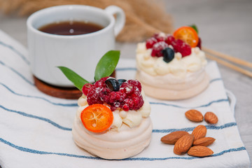 Pavlova meringue cake with cream and small fruits
