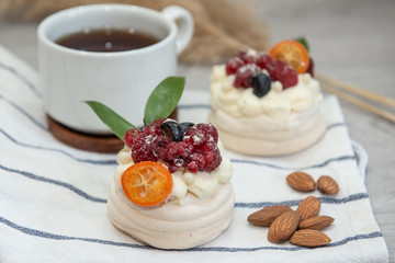 Pavlova meringue cake with cream and small fruits