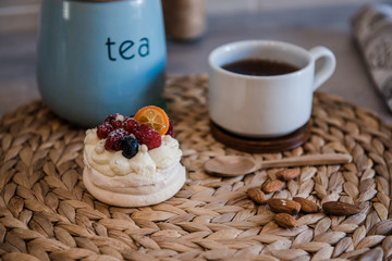 Pavlova meringue cake with cream and small fruits