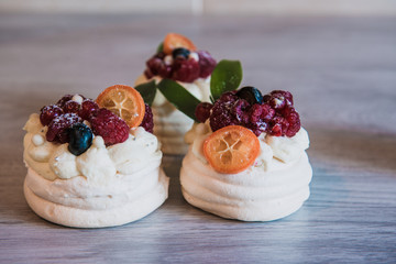 Pavlova meringue cake with cream and small fruits