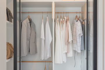 modern closet with clothes hanging on rail