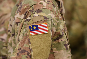 Malaysia flag on soldiers arm (collage).