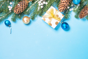 Christmas background - fir tree and decorations on blue top view
