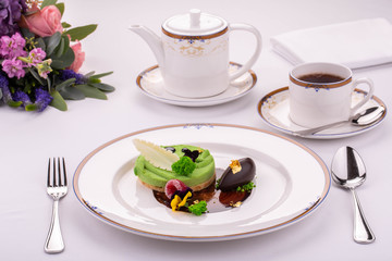 Giving of a dessert at restaurant with a teapot of black tea