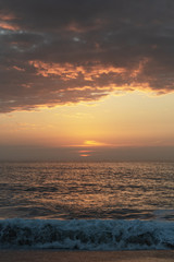 Naklejka na ściany i meble Sunset time in the Atlantic ocean, Nazare, Portugal.