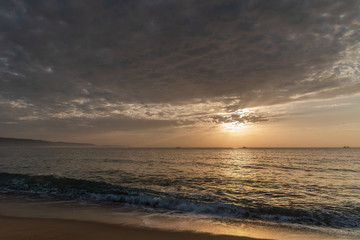 Naklejka na ściany i meble Sunset time in the Atlantic ocean, Nazare, Portugal.