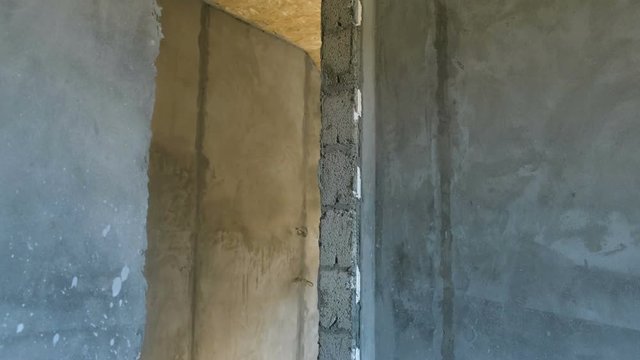 Rough finish empty house with osb ceiling. Concrete walls and floor.