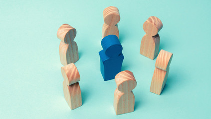 The concept of leadership in a business team. A crowd of workers stand in a circle and listen to their mentor, leader or boss. Improving work efficiency and developing a future action plan in the team