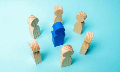 The concept of leadership in a business team. A crowd of workers stand in a circle and listen to their mentor, leader or boss. Improving work efficiency and developing a future action plan in the team