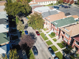 Aerial view classical townhouses in Chicago with garden and detached garage. Colorful condo near...