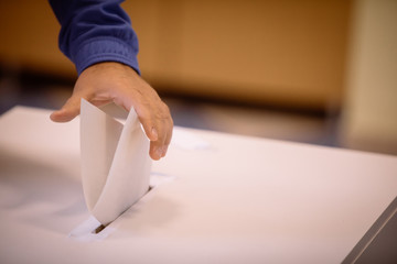 Person voting, casting a ballot