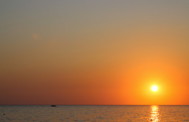 sunset on the horizon, yellow sky, the evening sea, the path from the sun on the water