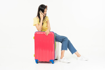 Beautiful young woman smiling and pulling pink color luggage isolated on white background.Woman going to summer vacation.Travel trip funny...