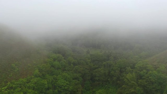 Aerial view of Chocolate Hills, picturesque geological formation on Bohol island, low-level clouds - landscape panorama of Philippines from above, Asia 