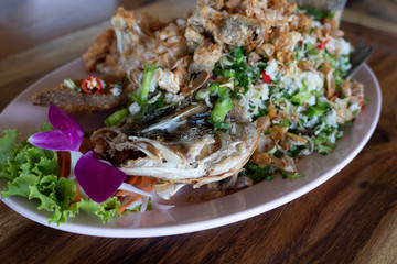 Fried fish is cut into pieces