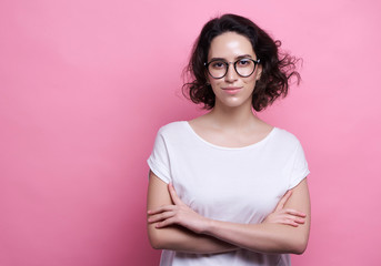 Fototapeta premium Studio shot of good looking intelligent female professor, have no much experience, wears big round spectacles. Caucasian college student recieves good proposal