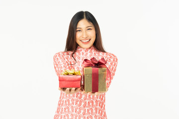 Photo of asian curious woman in red dress rejoicing her birthday or new year gift box. Young woman holding gift  box with red bow being excited and surprised  holiday present isolated white background