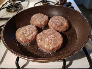 Juicy appetizing cutlets from a mixed different types of meat in a dripping pan in oil