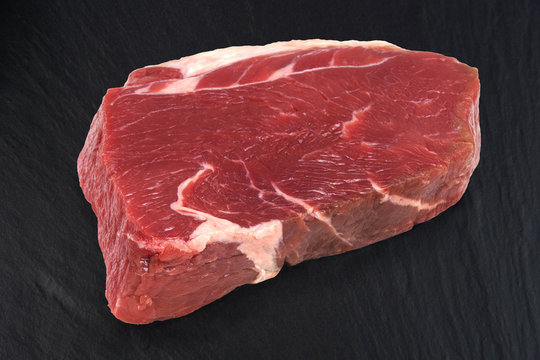 Fresh beef on black background. Sirloin steak.