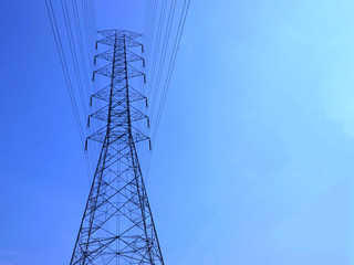 High voltage towers with sky background.
