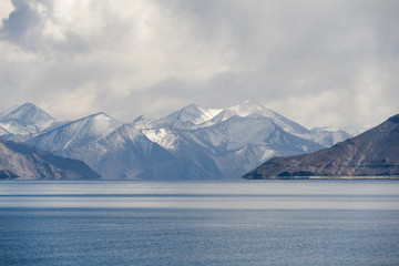 Fototapeta na wymiar Pangong Lake or Pangong Tso in the Himalayas and snow mountain in background. Winter season in Leh Ladakh