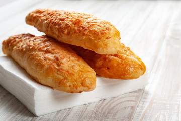 cheese buns, bread with cheese on a white wooden background
