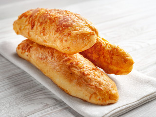 cheese buns, bread with cheese on a white wooden background