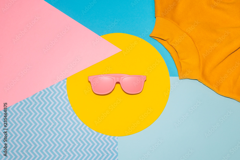 Wall mural part of of woman's yellow pullover and sunglasses on memphis style background. geometry minimal conc