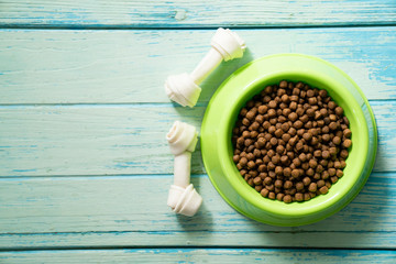 dog food and dog bone snack food on wood table