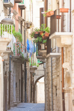 Molfetta, Apulia - Old balconies and a historical archway in an alleyway of Molfetta