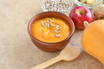 Roasted apple, pumpkin, ginger soup with cardamom, sprinkled with sunflower seeds, copy space