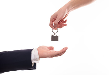 Hand of businessman passing a set of apartment keys to another hand. Clipping path isolated on white. the property
