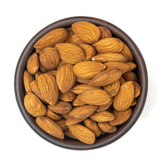 Almonds in brown bowl isolated on white background