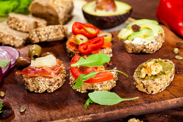 Collection of sandwiches on a cutting board and wooden table