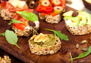 Collection of sandwiches on a cutting board and wooden table