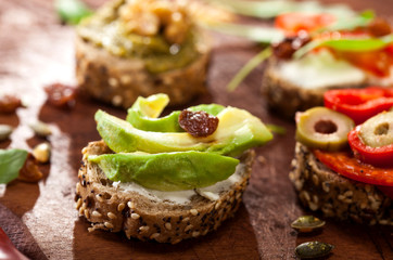 Collection of sandwiches on a cutting board and wooden table