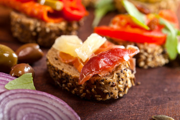 Collection of sandwiches on a cutting board and wooden table